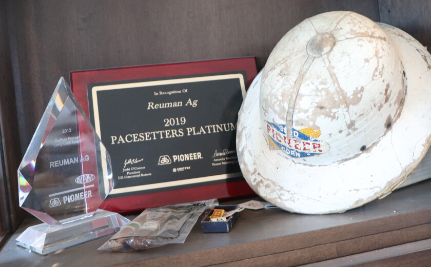 A trophy showcase at Reuman Ag of Presho, S.D., includes a display of plaques, cigars and a pith helmet, connected to their success as as a Pioneer Seed dealership.