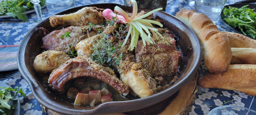 Roasted Ribs and Rhubarb in skillet with loaves of bread on side