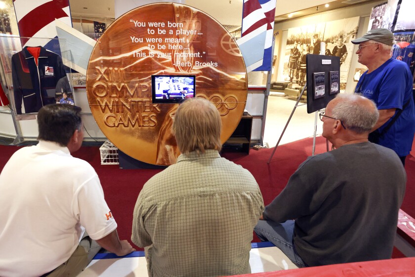 Men watching taped hockey game.