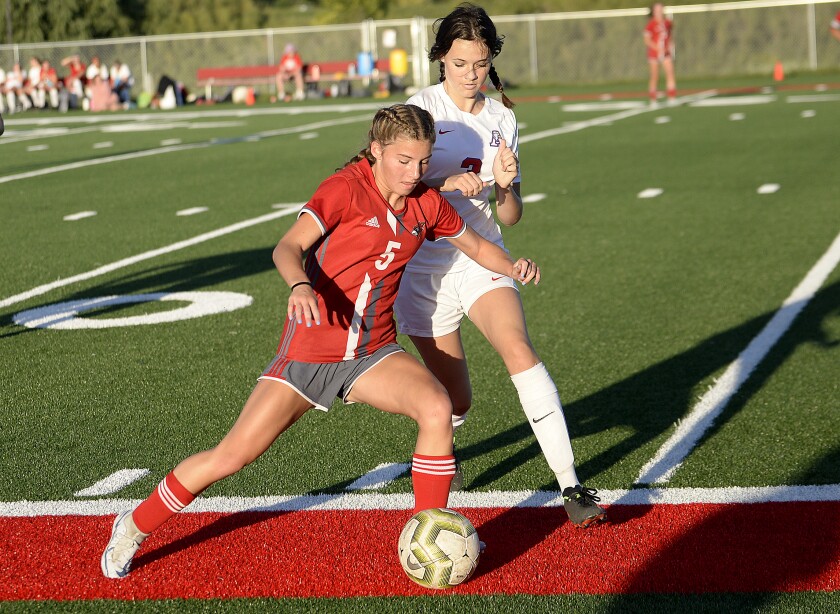 Willmar junior Becca Dawson, 5, keeps the ball away from St. Cloud Apollo's Briana Sanders during a Central Lakes Conference game on Tuesday, Aug. 30, 2022 at Willmar High School.