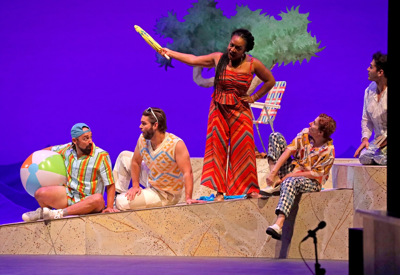Actors perform on stage.