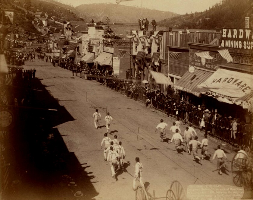 The great Hub-and-Hub race at Deadwood, South Dakota on July 4, 1888 between the only two Chinese hose teams in the United States. The two teams are pulling a hose and wagon with spectators..jpg