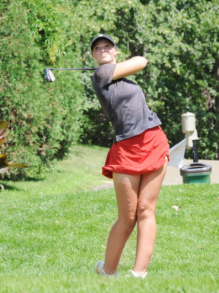 Caroline Monty launches a shot from the tee box towards the par