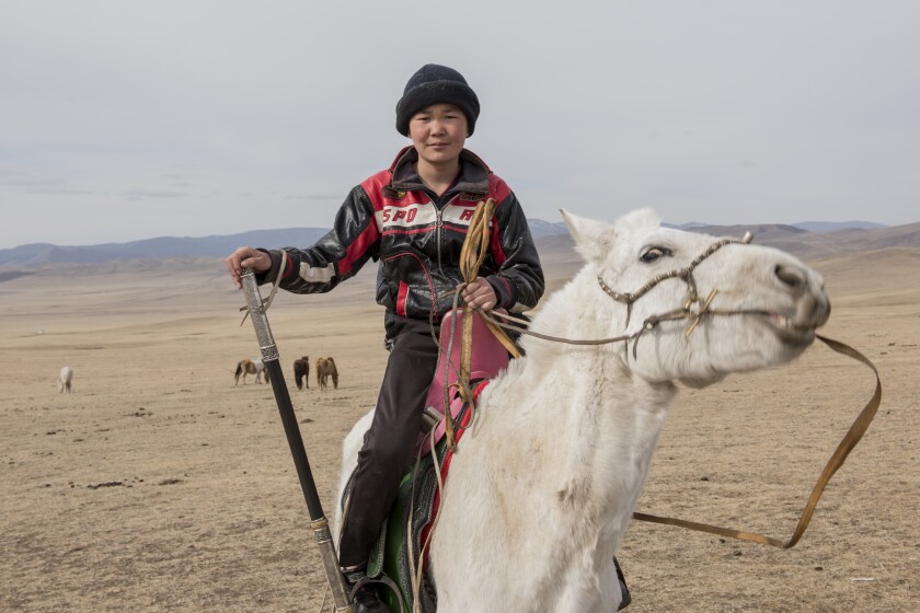A young man riding a horse in Mongolia..jpg