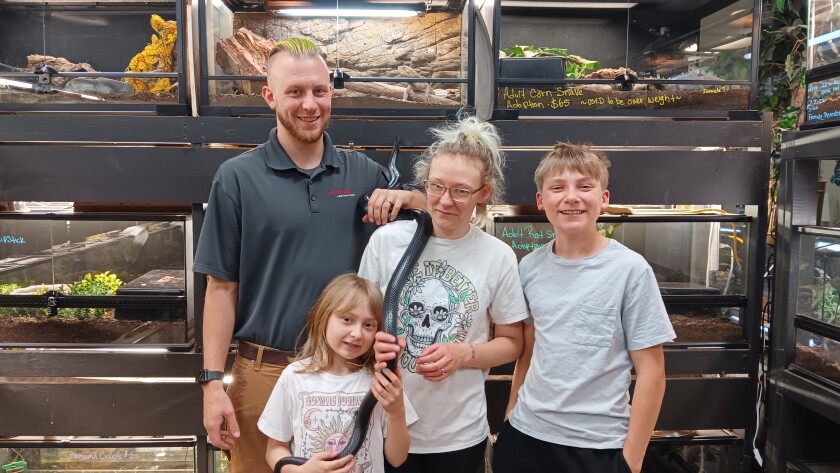 Cassie Reynolds, owner of Ectothermic Nirvana, poses with her husband, children and a snake on Friday, June 13, 2025.
