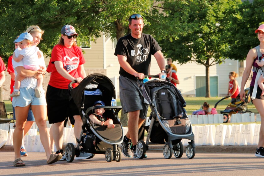 From left to right: Brittany Young, Lindsay Eilts and Brett Young walk in honor of those who have battled cancer on Friday evening at the Heart and Sole Cancer Walk. (Sam Fosness / Republic)