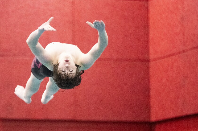 Willmar sophomore Brendan Pappenfus performs a dive