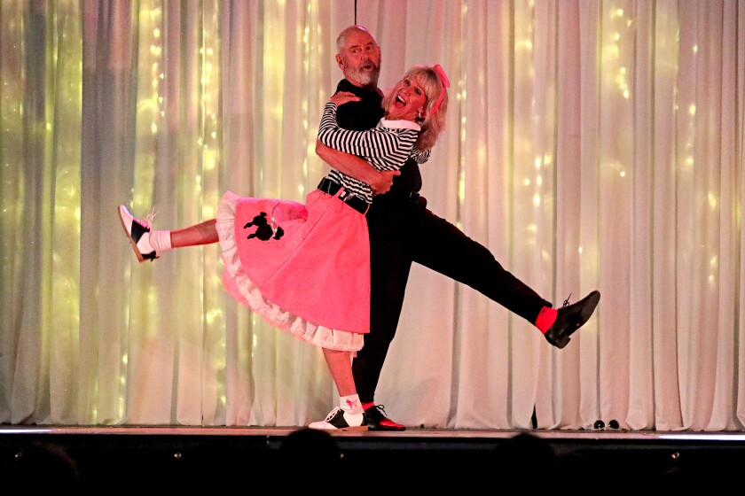 Todd and Connie Lyscio dance in '50s sock hop attire on stage.
