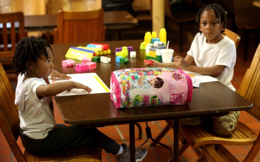 Two kids sitting at a table