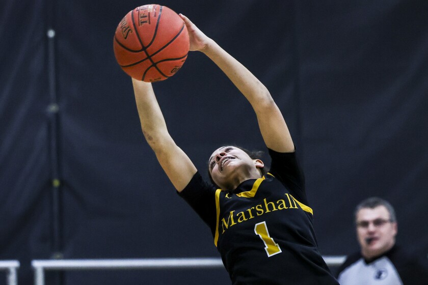 high school girls play basketball