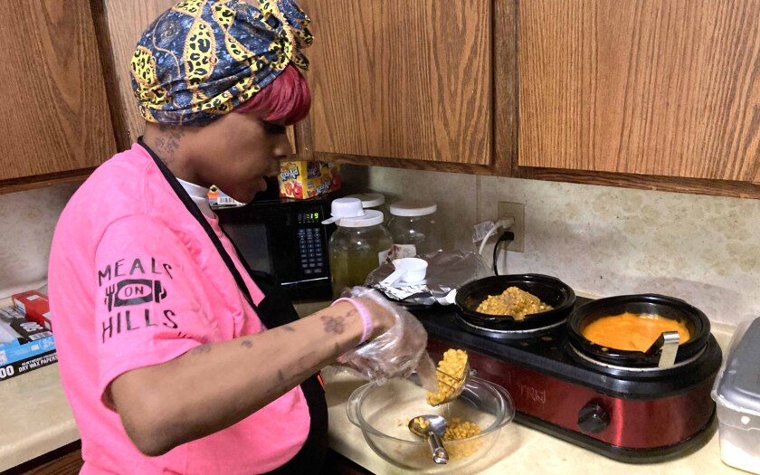 Woman scoops corn in a kitchen