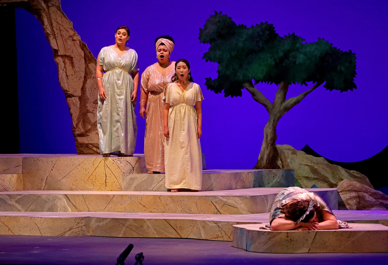 Actors perform on stage.