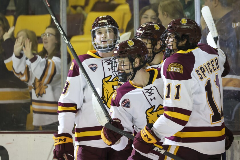 College hockey players play game in indoor arena