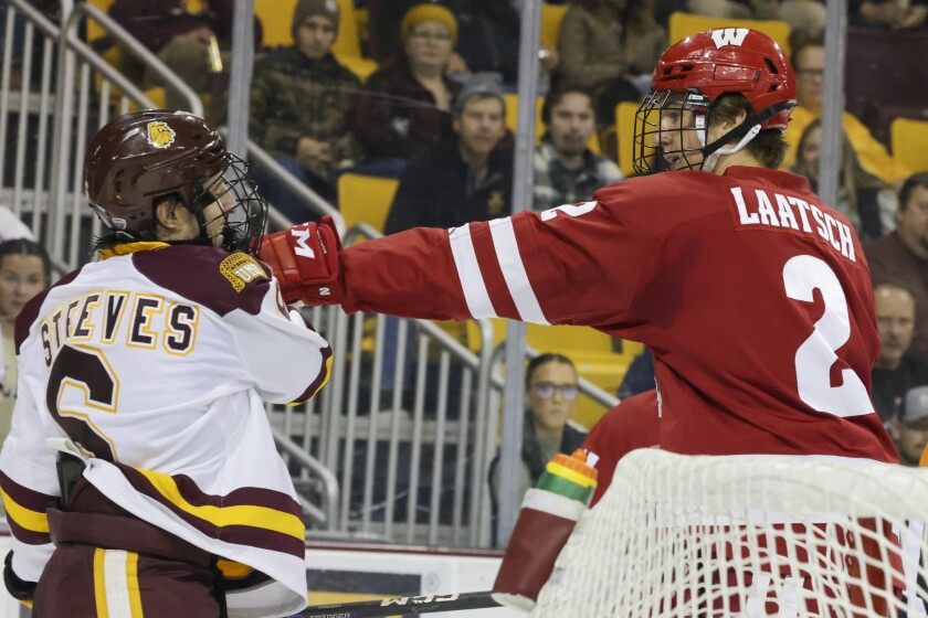 college hockey players play ice hockey