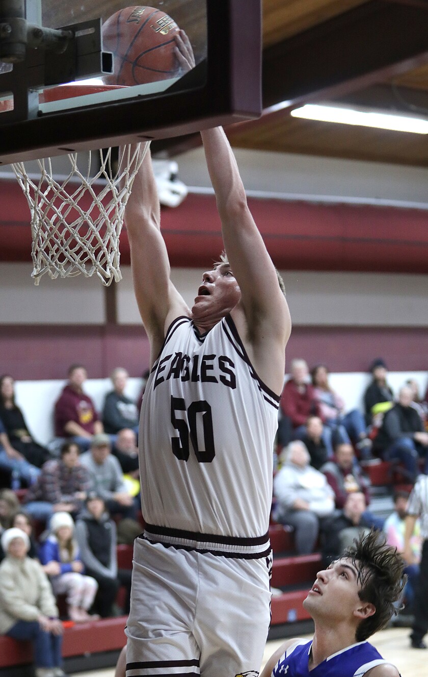 Solon Springs’ Isaiah Kastern (50) dunks the ball in front of Mellen’s Tommy Zakovec (11)