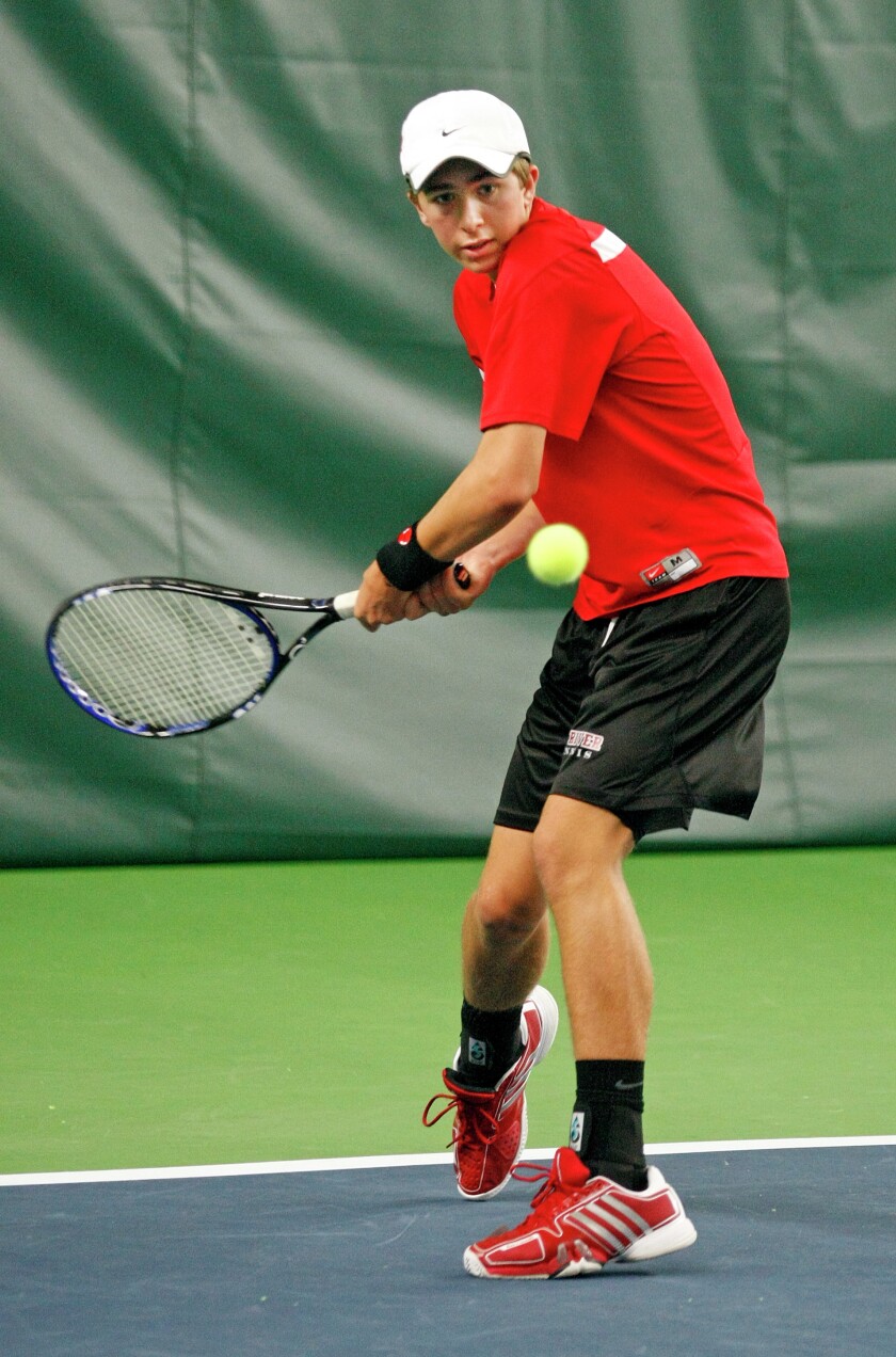 Grand Forks Red River's Greg Wischer returns a volley