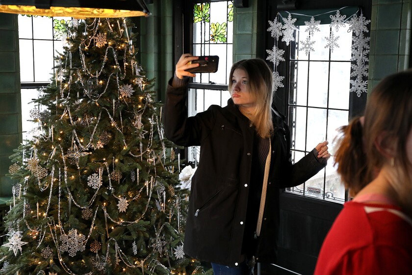 Aurora Doll, a student at Superior High School, takes a photo in the Breakfast Room at Glensheen Mansion