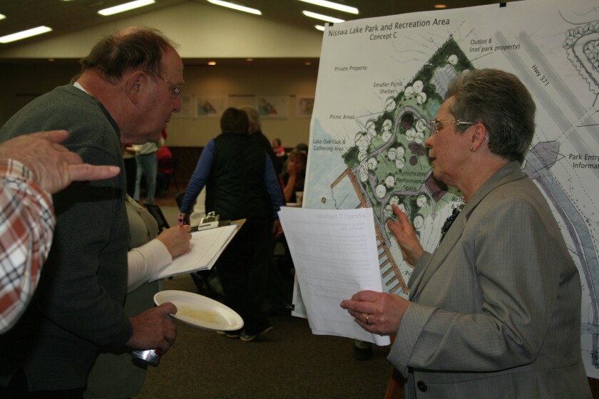 Carolyn Blanck of the Nisswa Lake Park Steering Committee explains one of three park development options at an open house Thursday, Feb. 5, at the Nisswa Community Center, where people were invited to share their thoughts about the park.Photo by Nancy Vogt