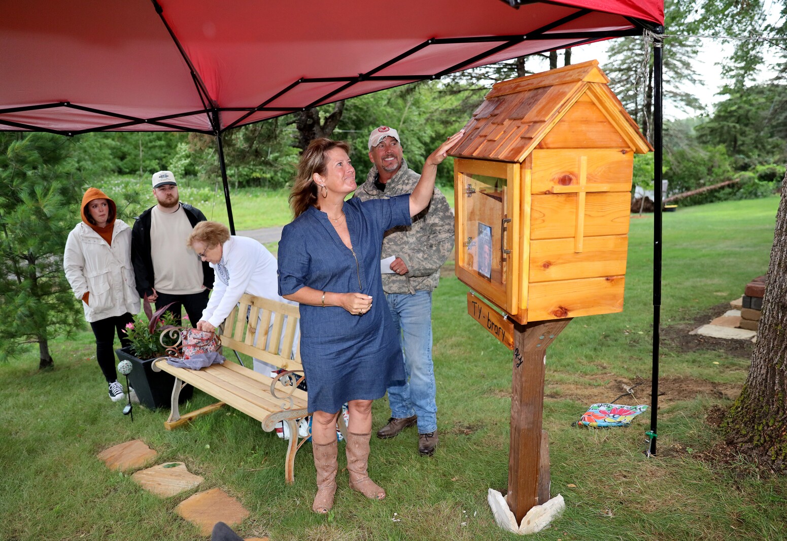 Ty's mother and father look at the newly installed little library.