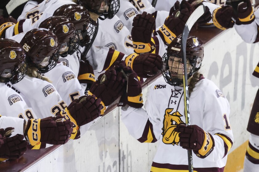 college women play hockey at arena