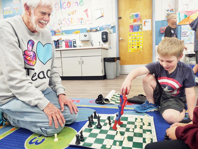 Grandpa Bob Foss, a Foster Grandparent at Parkers Prairie Elementary School, plays chess against Spiderman controlled by a Parkers Prairie kindergarten student.