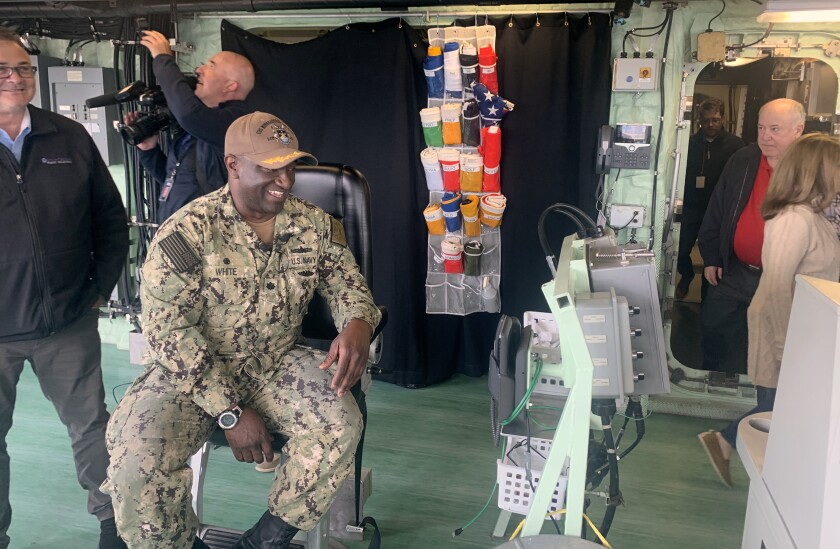 USS Minneapolis-Saint Paul Cmdr. Alfonza White smiles while seated
