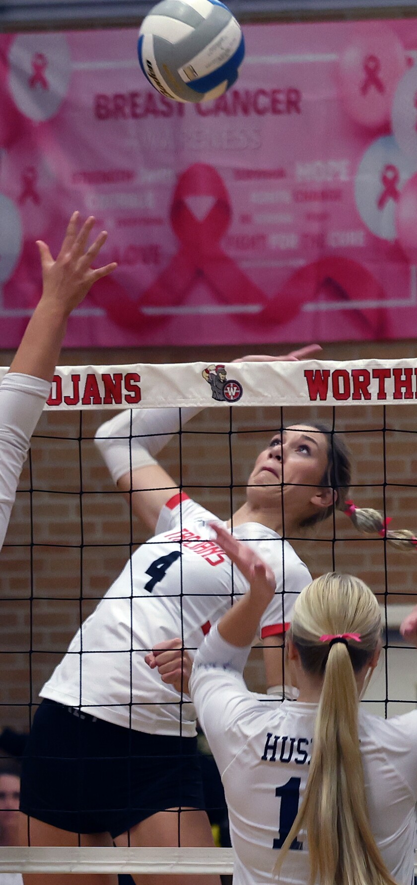 Trojans' Madison Beckman (4) shoots the ball past Jackson County Huskies defenders during Tuesday night in Worthington.