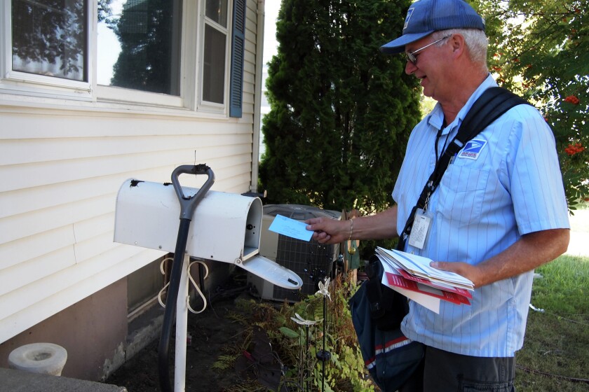 Faces of the Boom: Former oil industry manager finds job in post office ...