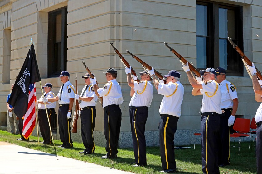 The color guard performs a 21-gun salute
