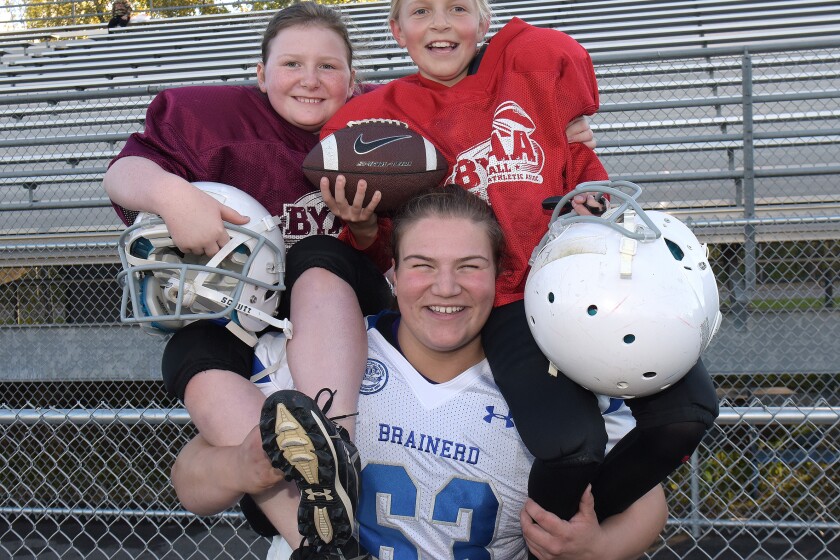 Brainerd Youth Athletic Association football players Kylee Soens (left) and Natasha Van Slyke are hoisted on the shoulders of Brainerd Warrior senior Lili Charlier at practice last week. Steve Kohls / Brainerd Dispatch Video and Gallery