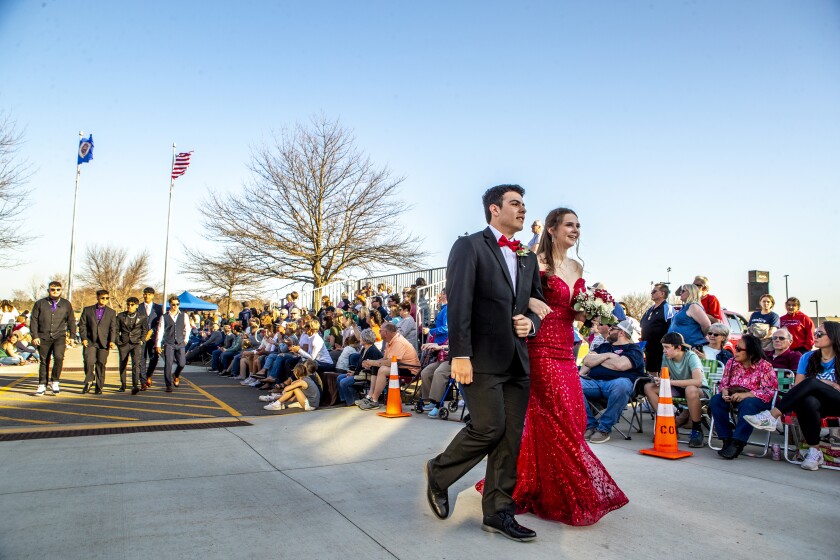 Willmar High School prom attendees walk before hundreds of friends and family members during grand march on Friday, May 6, 2022.