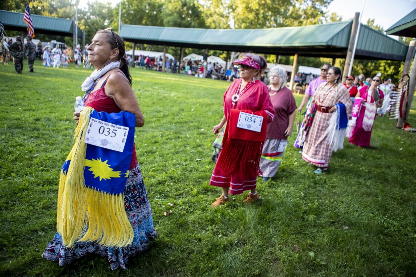 Women take part in the Grand Entry during the Upper Sioux Community's traditional WACIPI on the evening of Friday, August 5, 2022.