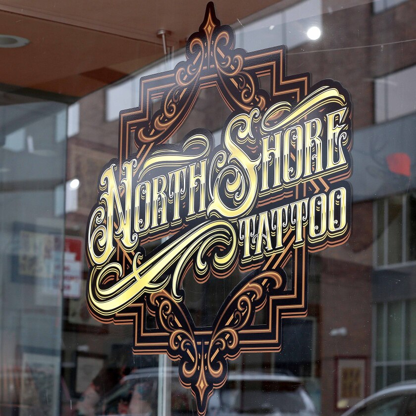 North Shore Tattoo Co. logo in display window.