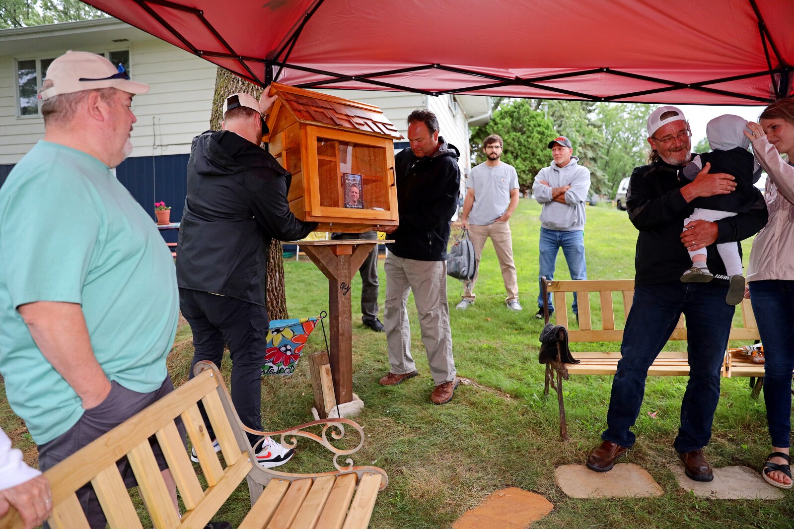 People watch as the little free library is installed