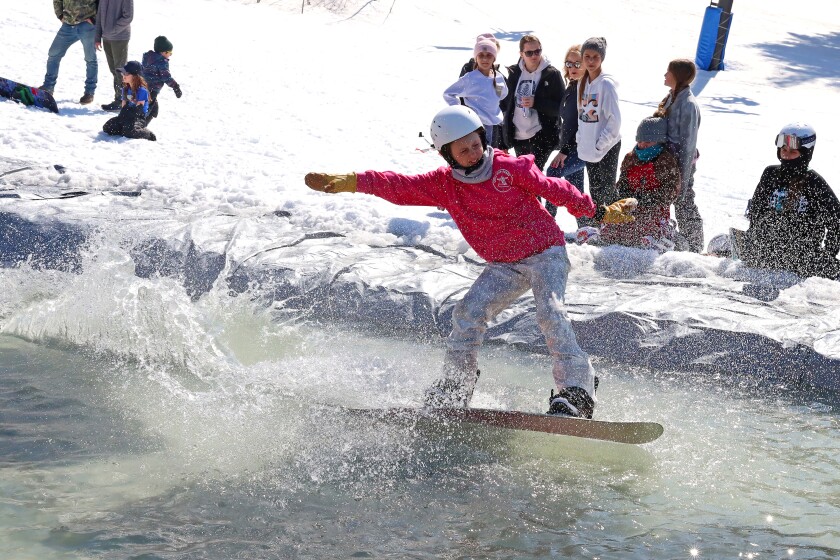 Skiers and snowboarders participate in the water skip at Mount Ski Gull on Saturday, April 8, 2023, for the end of the season.
