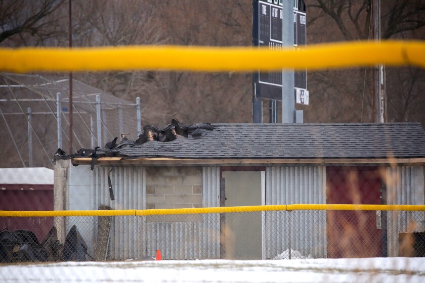 Damage to a roof of a structure at a little league baseball field in the winter.