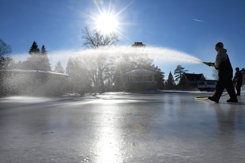 Jim Schulz, Brainerd Parks and Recreation Department, on Monday sprays a coat of water on the Gregory Park skating rink. Steve Kohls / Brainerd Dispatch