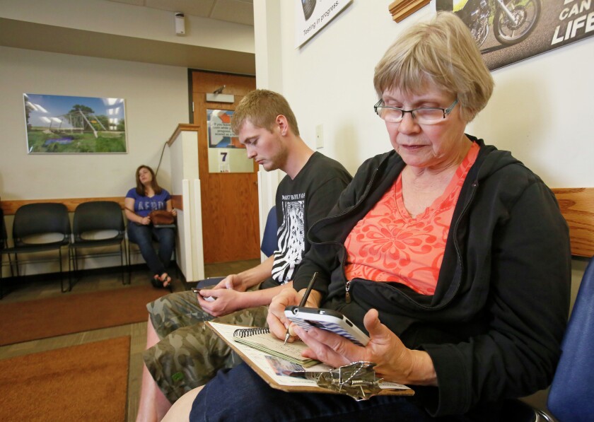 People fill in the waiting area at the Department of Motor Vehicles in Fargo, N.D. on Wednesday, July 1, 2015. Carrie Snyder / The Forum