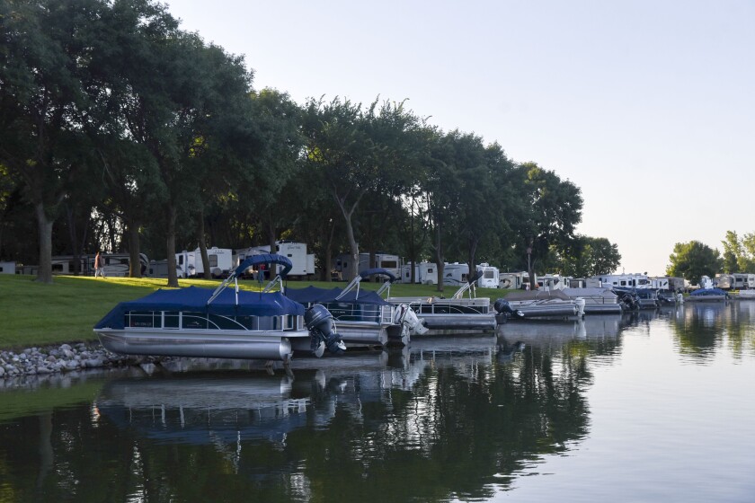 Erica Dischino / Tribune Pontoons with sea legs are pulled up along the shoreline at Big Kandiyohi Lake County Park West Monday evening, creating a serene setting.