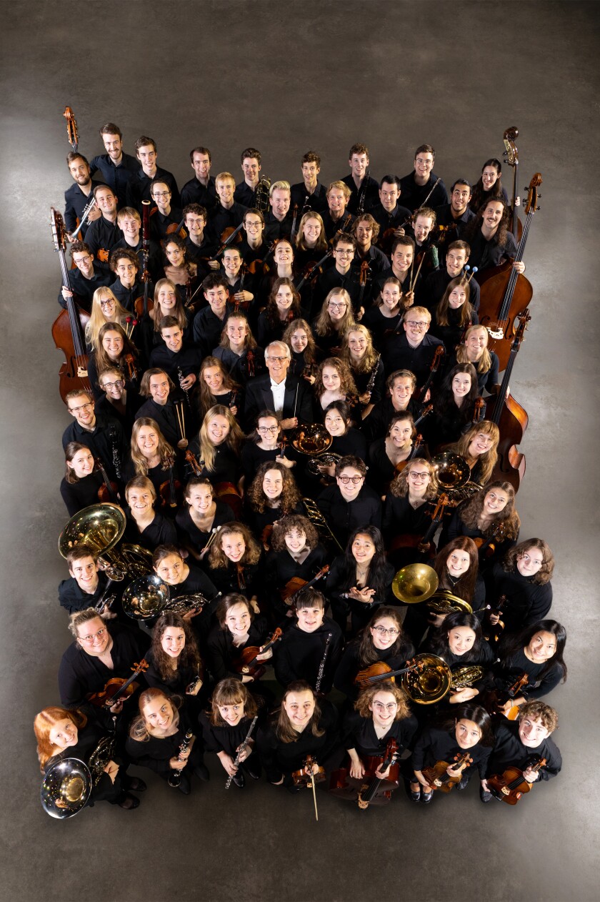 Overhead photo of St. Olaf Orchestra members posing together with their instruments.