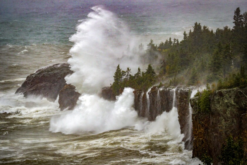 A large wave shoots water over 100 feet in the air as it hits a cliff on Lake Superior near the mouth of the Crystal Creek in Tettegouche State Park during Wednesday's storm on the North Shore. (Clint Austin / caustin@duluthnews.com)
