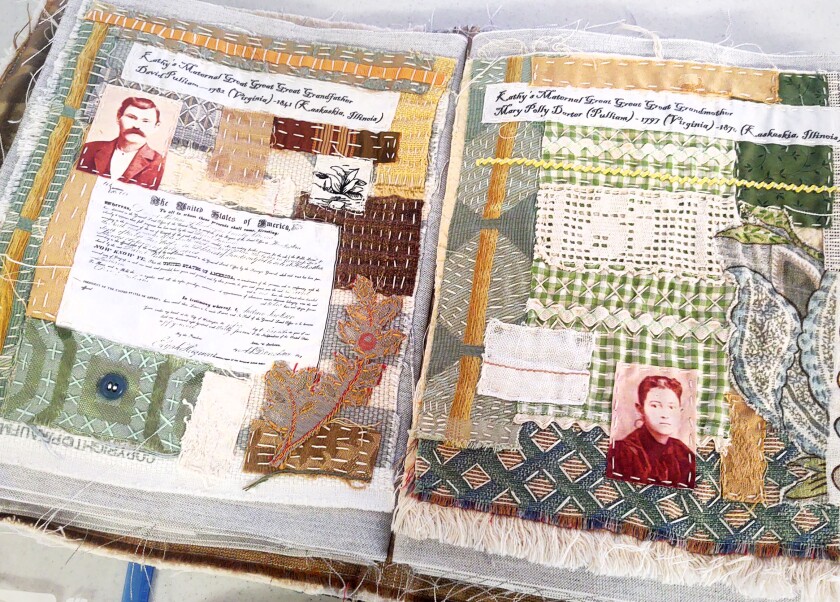 Two pages from Kathy Fauth's fabric family history book with photos and documents on a quilt-like backing of fabric scraps.
