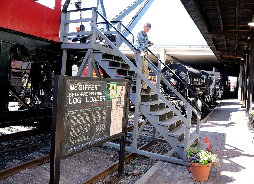 Ken Srigley, of Greeneville, Tennessee, climbs down from an exhibit at the Lake Superior Railroad Museum