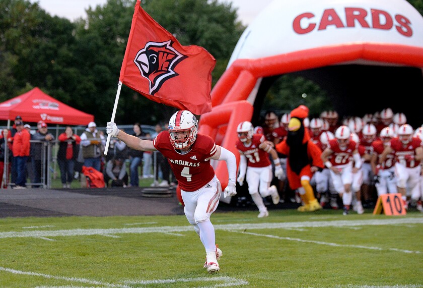 Willmar senior Jacob Streed leads the Cardinals football team onto the field for its homecoming game against Delano on Friday, Sept. 30, 2022 at Hodapp Field.