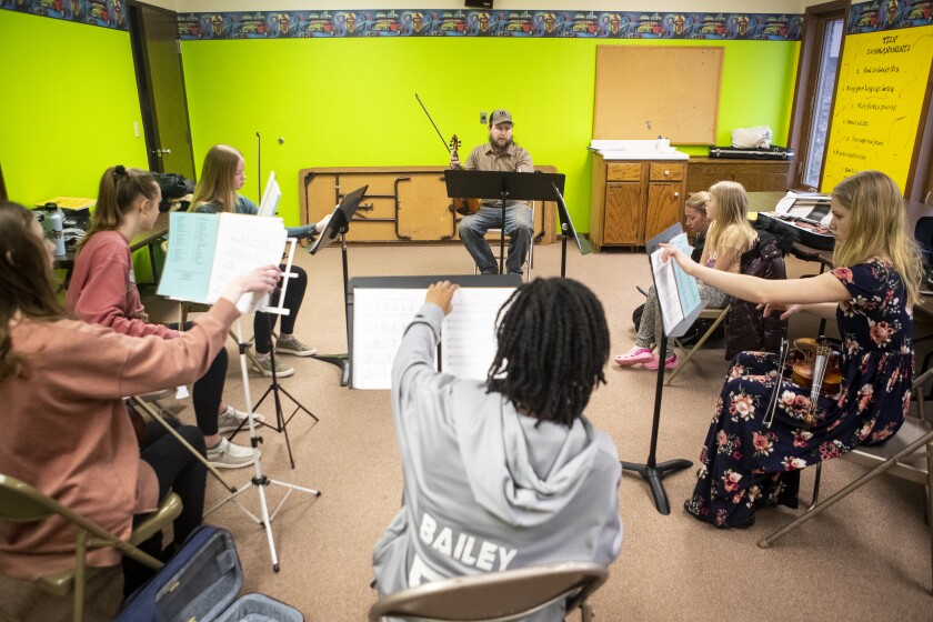 Dempsey Schroeder of Minneapolis teaches younger fiddle players in a workshop at Hope Lutheran Church in Sunburg on Sunday, April 3, 2022.