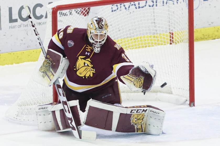 College Men's hockey players compete on Olympic size ice sheet