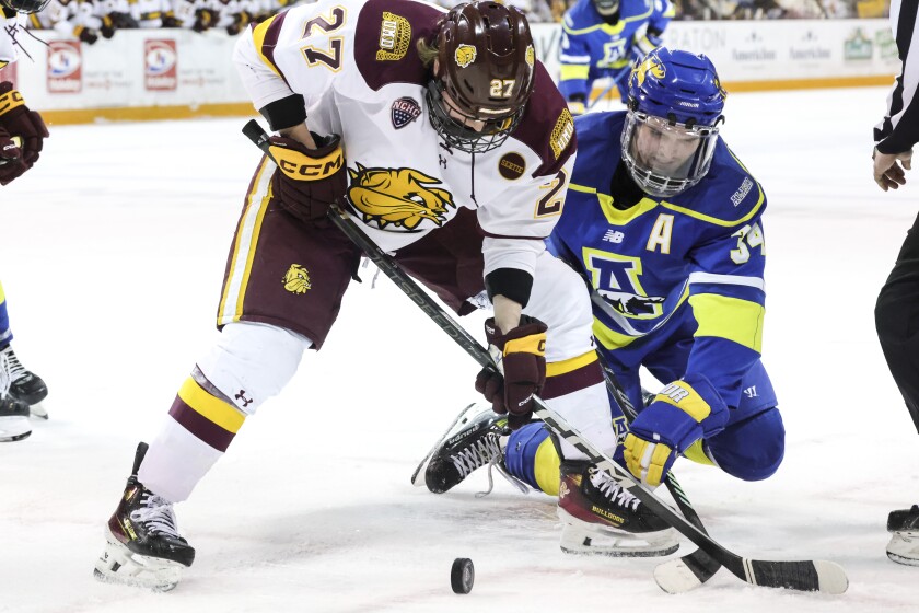 college men play ice hockey