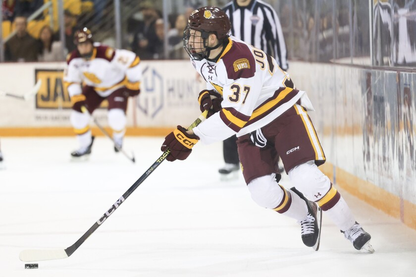 college men play ice hockey