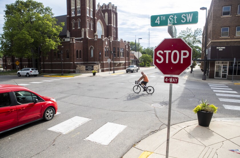 A cyclist cruises through the intersection of Becker Avenue and 4th Street in downtown Willmar on Thursday, July 14, 2022. Through the help of Willmar's downtown streetscape plan, this intersection, among others, will see the installation of bump-outs meant to slow traffic and make the walking distance from curb to curb shorter for pedestrians.
