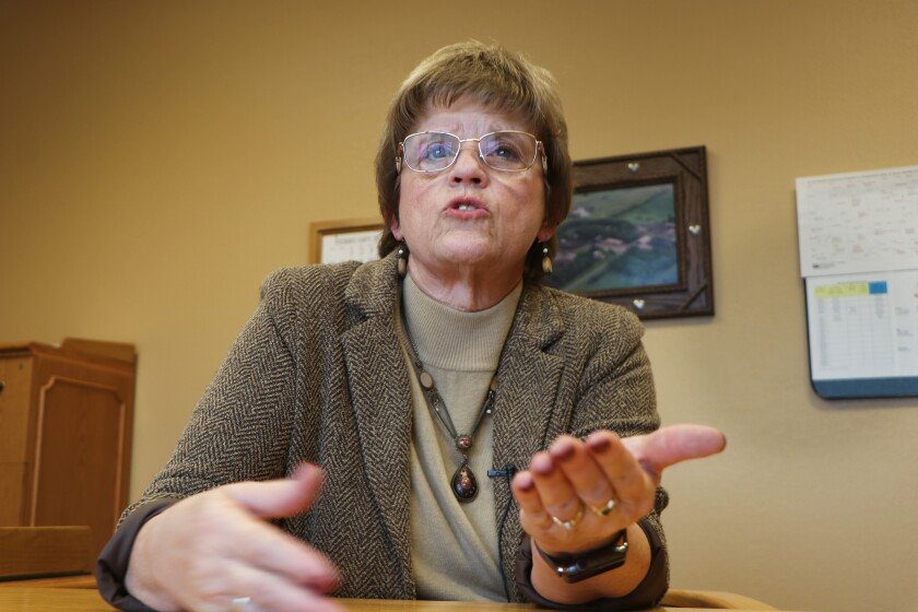 A woman gestures with her hands in a U.S. Department of Agriculture office.